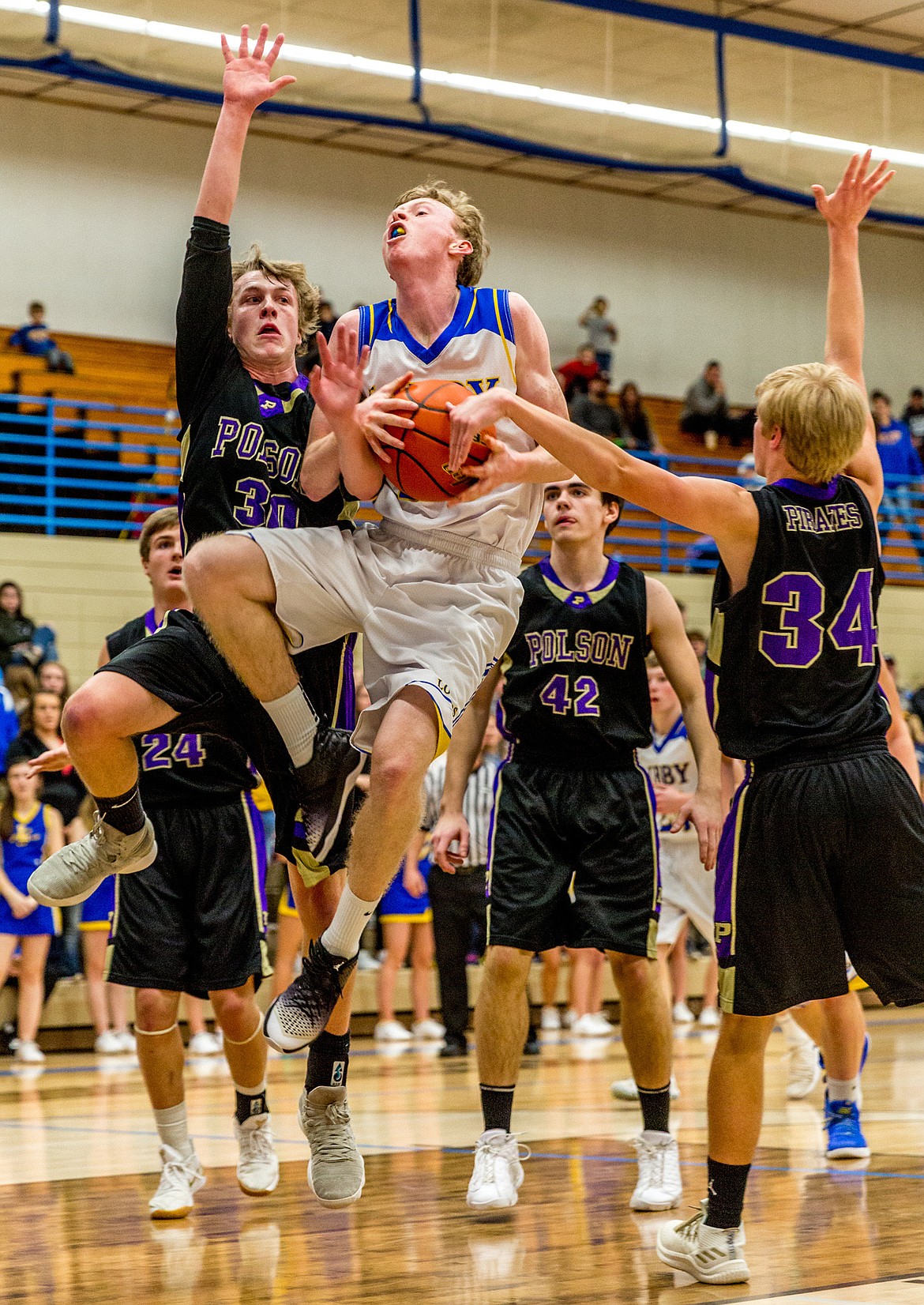 Libby's Ryggs Johnston is fouled by Polson's Conner Lanier Saturday. (John Blodgett/The Western News)