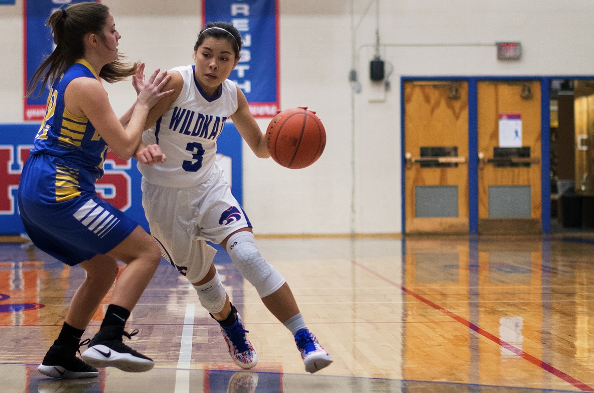 Dani Douglas drives past a Libby defender in the Wildkats 52-41 win over the Lady Loggers Friday. (Jeremy Weber photo)