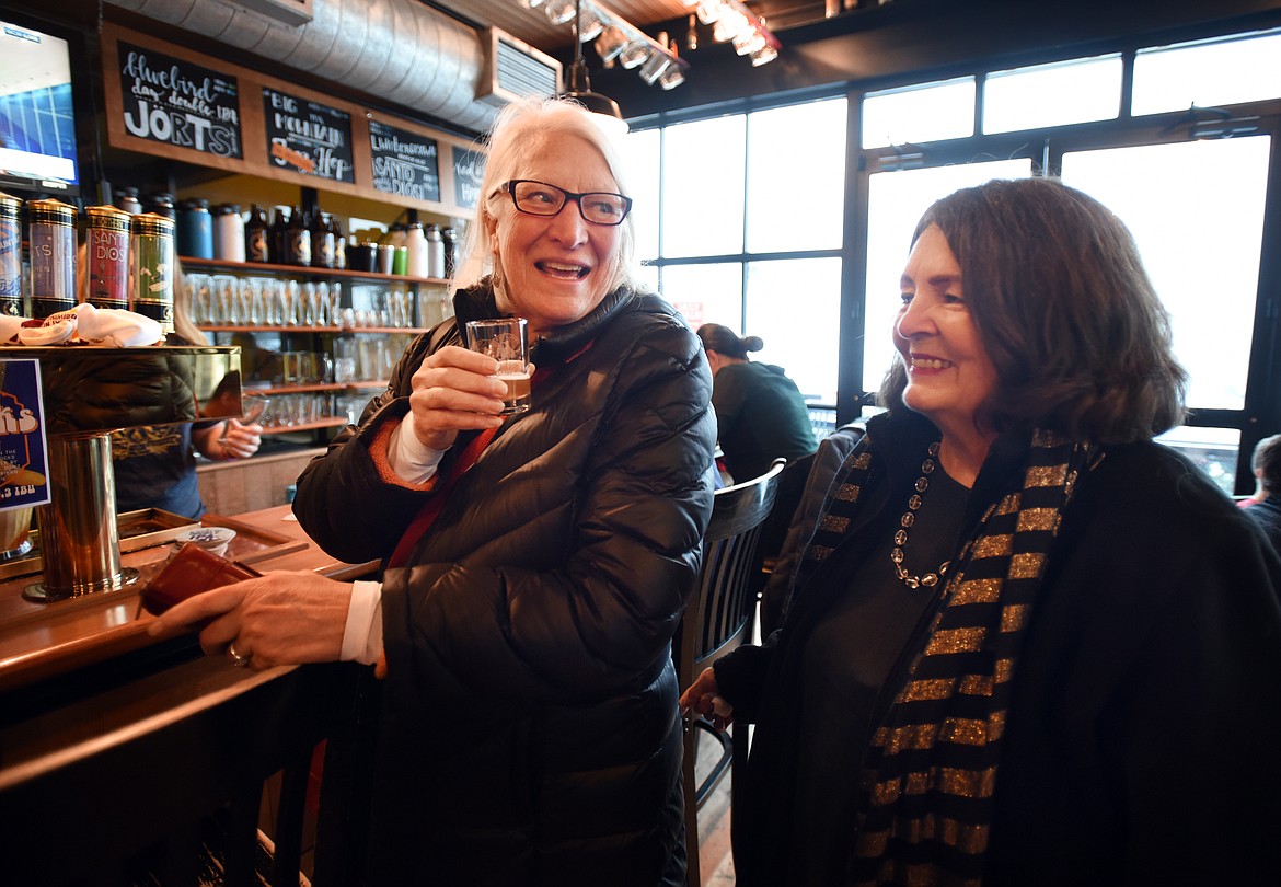 Gayle MacLaren, left, and Lonnie Porro of the Whitefish Theatre Company try a sample of Ski Socks American Sour at the Great Northern Brewing Company on Thursday, January 4, in Whitefish.(Brenda Ahearn/Daily Inter Lake)