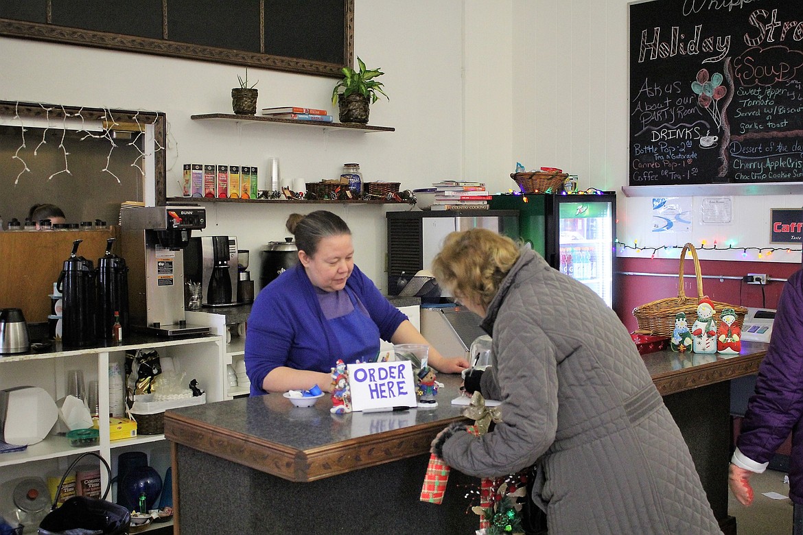 Owner-operator Michele VanTassel (left) helps a customer at the new Whipped Up Cafe located in the Old Schoolhouse in Superior. The cafe features good old-fashioned comfort food including breakfast, lunch and dinner. (Kathleen Woodford/Mineral Independent)