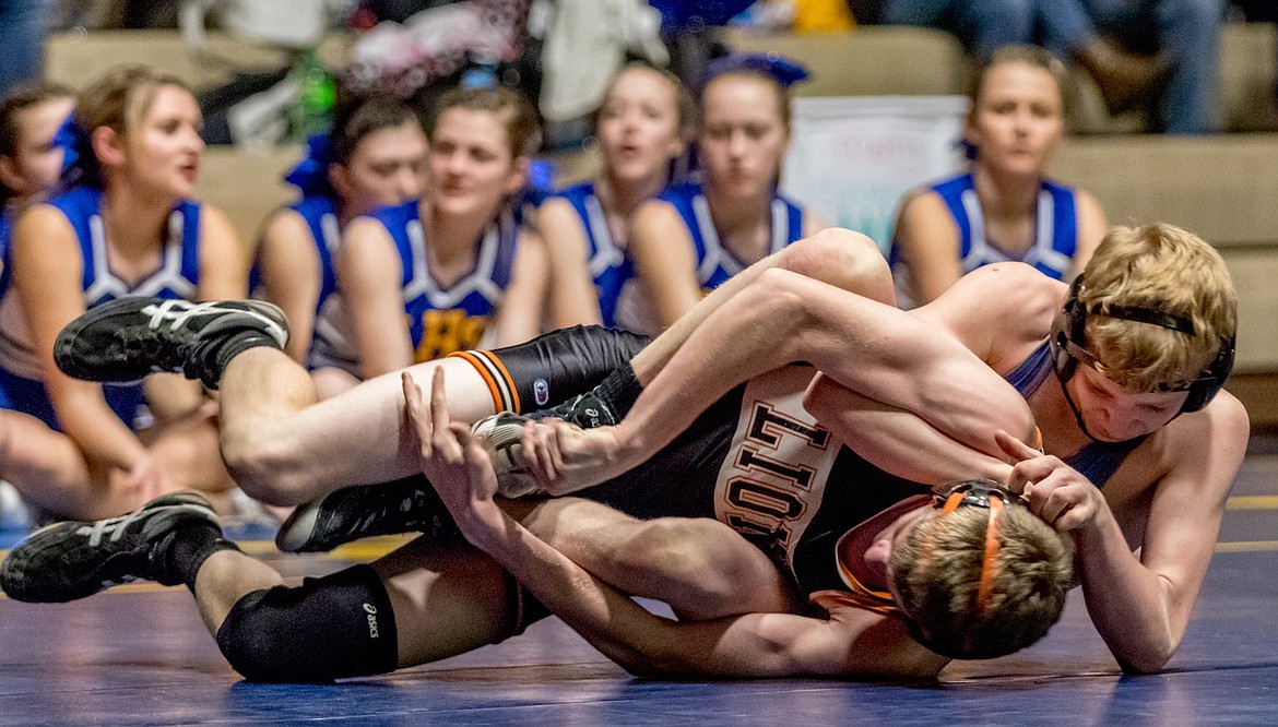 Zack Morrison of Libby tries to run the power half from the leg ride position against Eureka&#146;s Kyle Durden.