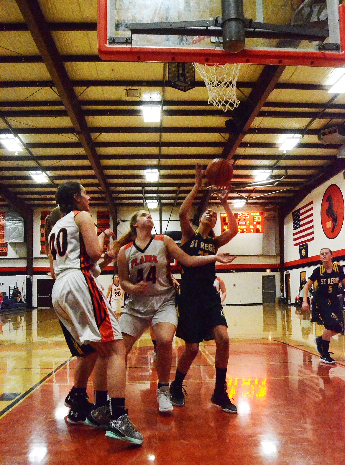 Kara Altmiller(40) and Jessica Thompson(44) look to secure the rebound off the board to sink another basket (Erin Jusseaume/ Clark Fork Valley Press)