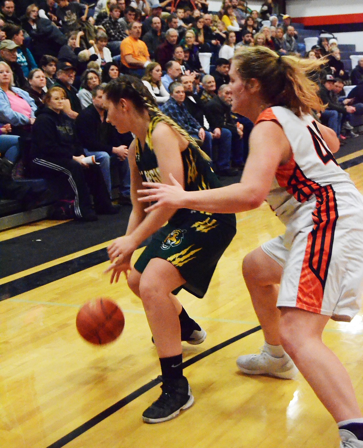 Jessica Thompson (44) plays good defense, making it hard for Kylee Thompson (34) to move the ball to fellow Lady Tigers. (Erin Jusseaume/ Clark Fork Valley Press)