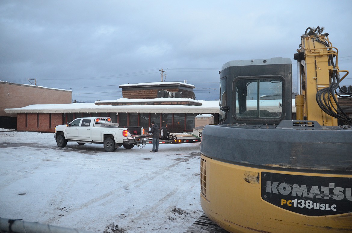 An excavator is parked in front of the Frank Lloyd Wright Building in downtown Whitefish on Wednesday evening. (Matt Baldwin/Daily Inter Lake)