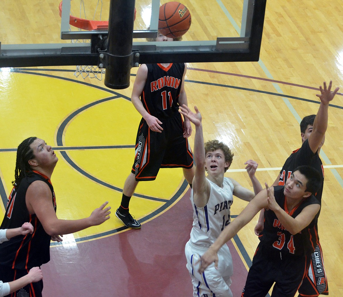 POLSON GUARD Robin Erickson (14) drives to the basket against the Ronan High School defense Friday night at Salish Kootenai College. (Photo by Jason Blasco/Lake County Leader)