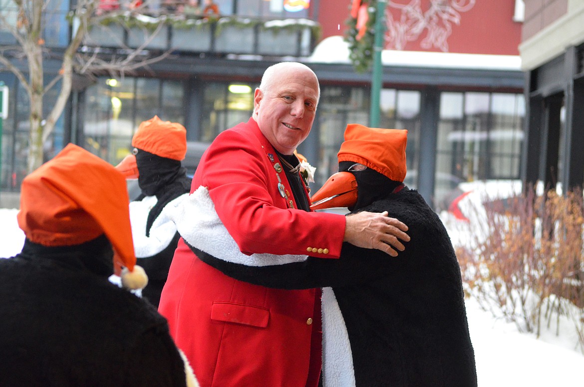 Mac McCracken, Prime Minister from 2005, hugs the Whitefish Winter Carnival penguins Saturday outside the O&#146;Shaughnessy Center before the coronation ceremony for the Carnival king and queen.  (Heidi Desch/Whitefish Pilot)