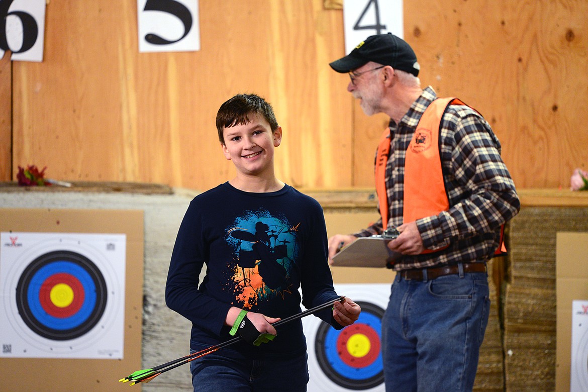 Carter Bechtle, 11, of Whitefish, retrieves his arrows during the barebow competition.