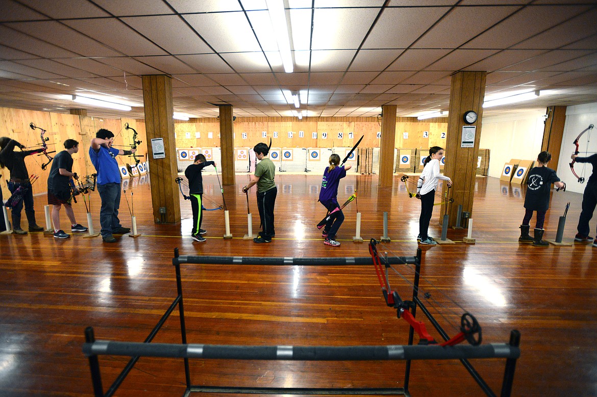 Competitors in the primitive bow division take aim at their targets during the the Flathead County 4-H Shooting Sports Invitational at the Flathead County Fairgrounds on Saturday.