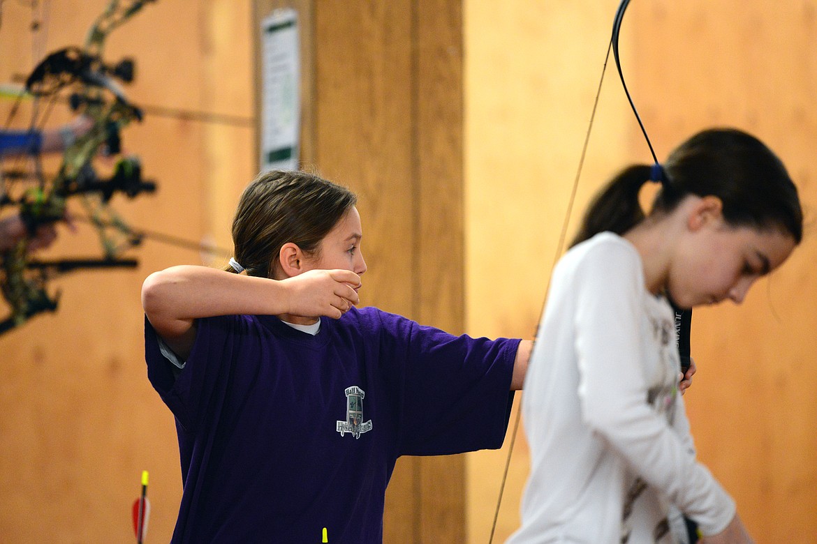 Kylie Aus, 10, of Kalispell, and a member of the Halfmoon Highlanders 4-H Club, competes in the primitive bow competition on Saturday.