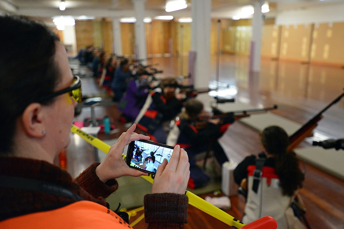 Instructor and range officer Nancy Baracker takes a photo with her phone during the Flathead County 4-H Shooting Sports Invitational at the Flathead County Fairgrounds on Saturday. (Casey Kreider/Daily Inter Lake)