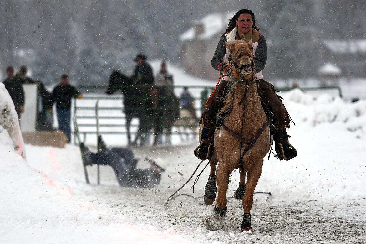 A skier takes a fall near the beginning of the course during Whitefish Skijoring at Big Mountain Ranch on Saturday. (Casey Kreider/Daily Inter Lake)