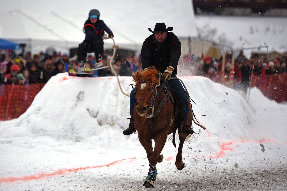 A horse and rider pull a skier through the course at Whitefish Skijoring at Big Mountain Ranch on Saturday. (Casey Kreider/Daily Inter Lake)