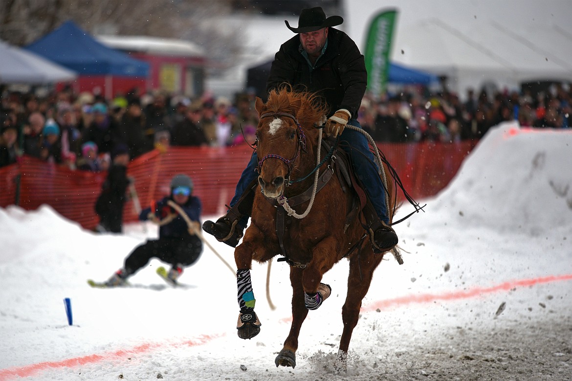 A horse and rider pull a skier through the course at Whitefish Skijoring at Big Mountain Ranch on Saturday. (Casey Kreider/Daily Inter Lake)