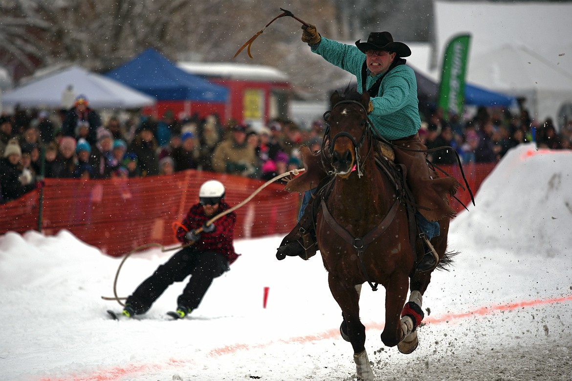 A horse and rider pull a skier through the course at Whitefish Skijoring at Big Mountain Ranch on Saturday. (Casey Kreider/Daily Inter Lake)