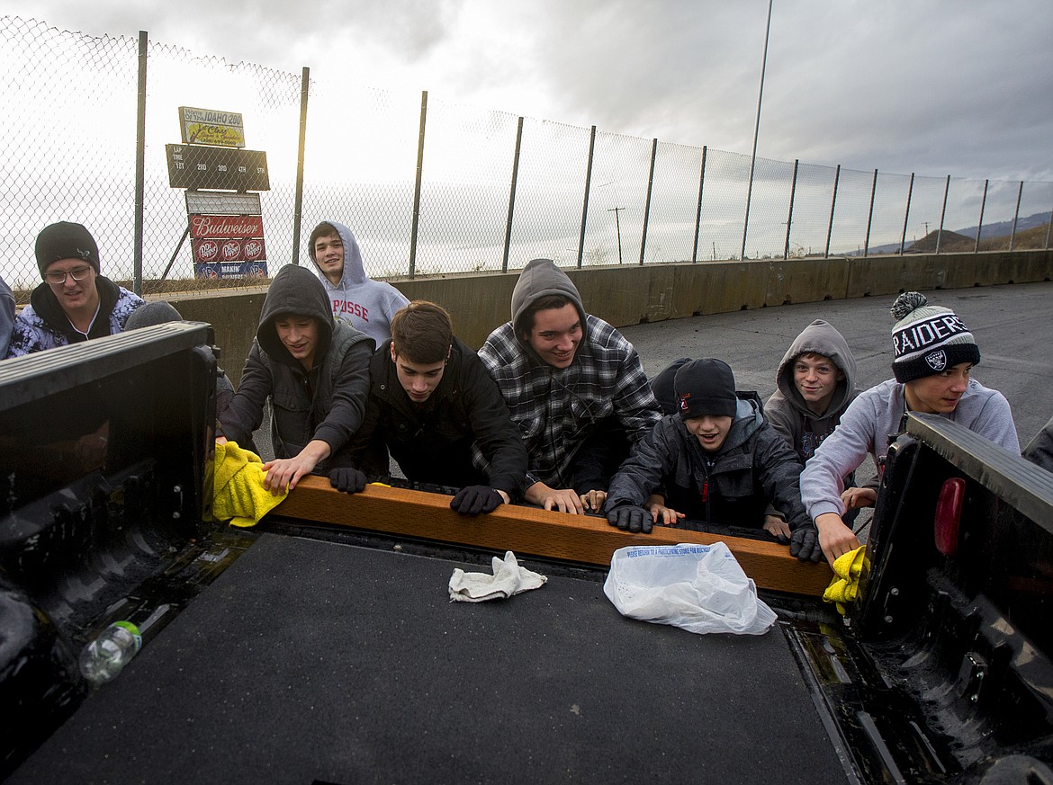 LOREN BENOIT/PressPost Falls High School wrestlers push a Ford Super Duty truck around the Stateline Speedway Wednesday afternoon after completing their Push for the Gold Challenge.