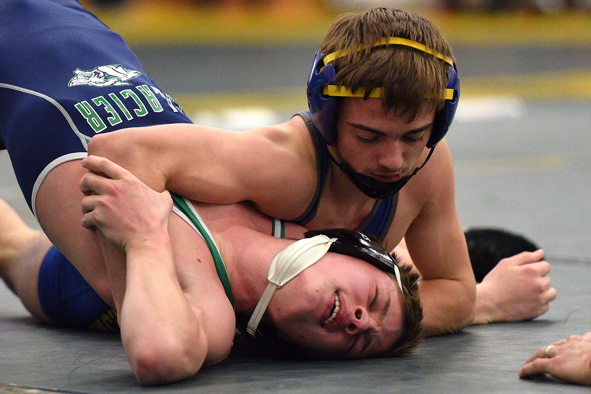 Libby&#146;s Buddy Doolin works toward a pin of Glacier&#146;s Bridger Beach at 113 pounds at the Whitefish Duals at Whitefish High School on Friday. (Casey Kreider/Daily Inter Lake)