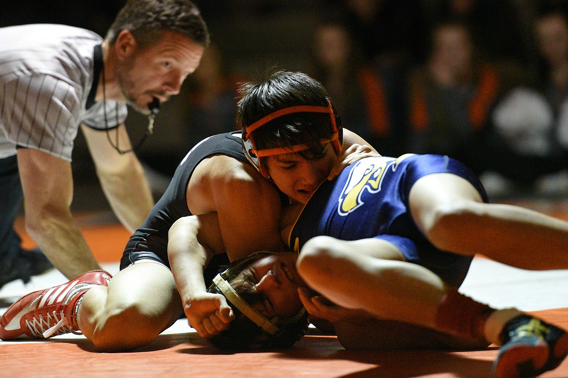 Flathead&#146;s Damian Naldrett works toward a pin of Missoula Big Sky&#146;s Alex Grandbois at 113 pounds at Flathead High School on Thursday. (Casey Kreider/Daily Inter Lake)