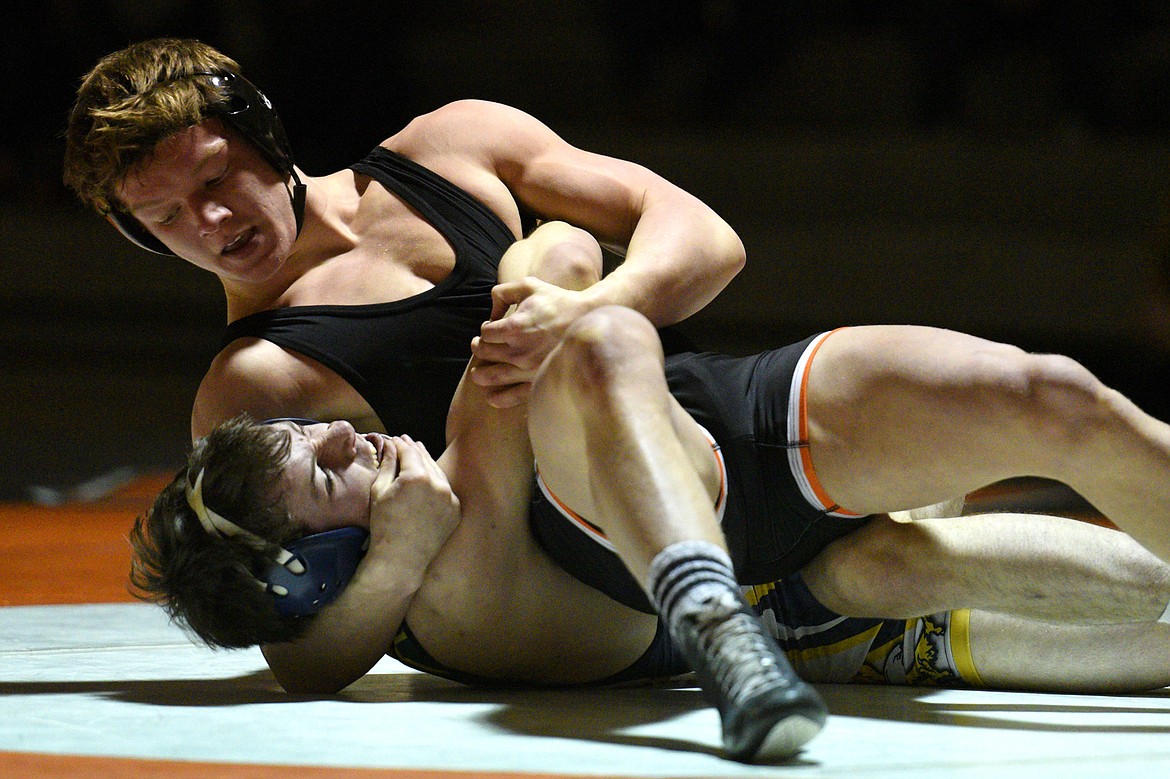 Flathead&#146;s Garett Rieke works toward a pin of Missoula Big Sky&#146;s Wyatt Shinn at 160 pounds at Flathead High School on Thursday. (Casey Kreider/Daily Inter Lake)