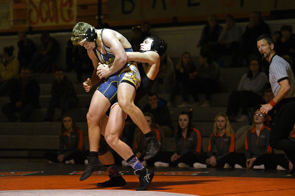 Flathead&#146;s Payton Hume lifts Missoula Big Sky&#146;s Mason Corcoran at 170 pounds at Flathead High School on Thursday. Hume won by pin. (Casey Kreider/Daily Inter Lake)