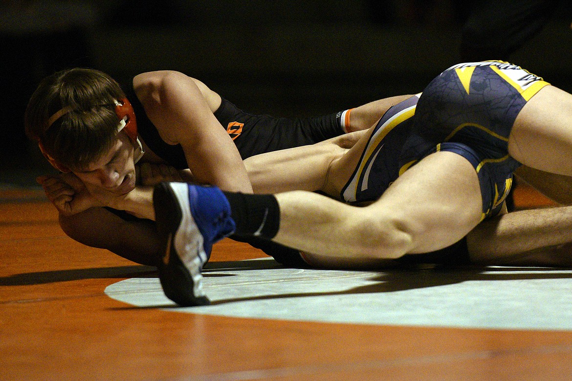 Flathead&#146;s Tanner Russell wrestles Missoula Big Sky&#146;s Kyle Gordon at 145 pounds at Flathead High School on Thursday. Russell won by decision. (Casey Kreider/Daily Inter Lake)