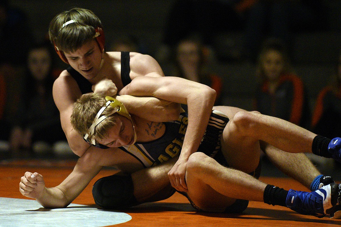 Flathead&#146;s Tanner Russell wrestles Missoula Big Sky&#146;s Kyle Gordon at 145 pounds at Flathead High School on Thursday. Russell won by decision. (Casey Kreider/Daily Inter Lake)