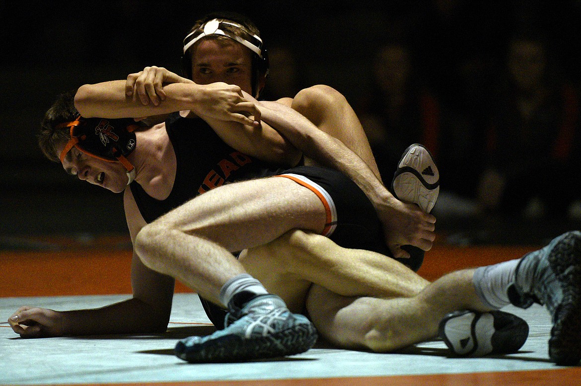 Flathead&#146;s Braden Comer wrestles Missoula Big Sky&#146;s Brody Skillicorn at 126 pounds at Flathead High School on Thursday. Comer won by minor decision. (Casey Kreider/Daily Inter Lake)