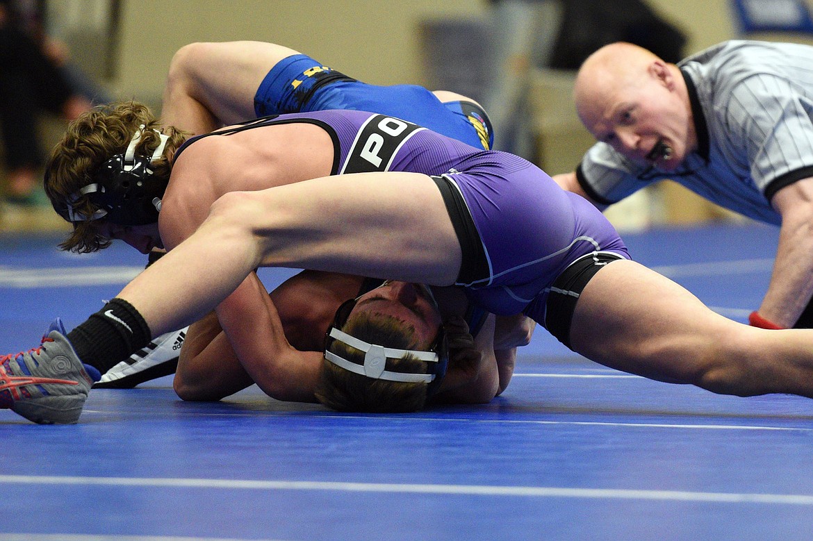 Polson&#146;s Parker Adler works toward a pin of Libby&#146;s Dawson Young at 152 pounds at Columbia Falls High School on Tuesday. (Casey Kreider/Daily Inter Lake)