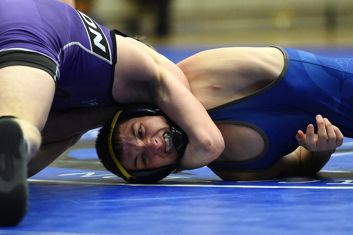 Polson&#146;s Bridger Wenzel works toward a pin of Libby&#146;s Cody Crace at 132 pounds at Columbia Falls High School on Tuesday. (Casey Kreider/Daily Inter Lake)