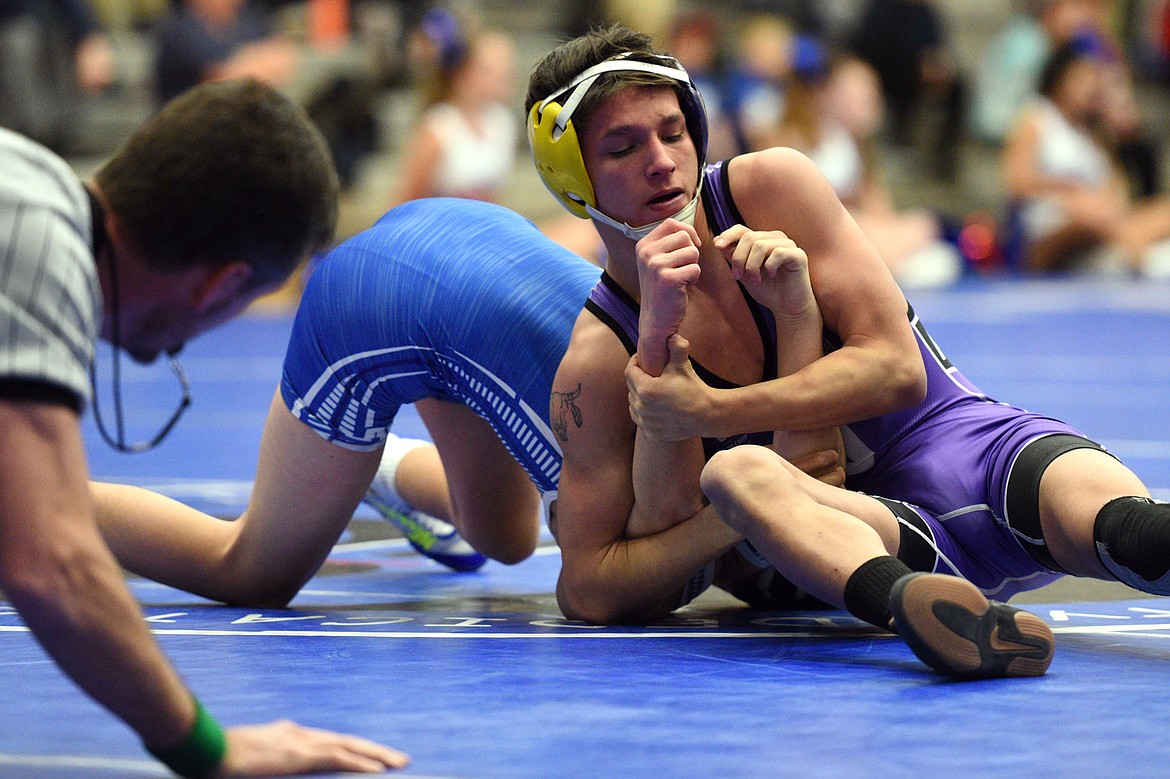 Polson&#146;s RJ PIerre works toward a pin of Columbia Falls&#146; Garhet Salminen at 113 pounds on Tuesday. (Casey Kreider/Daily Inter Lake)