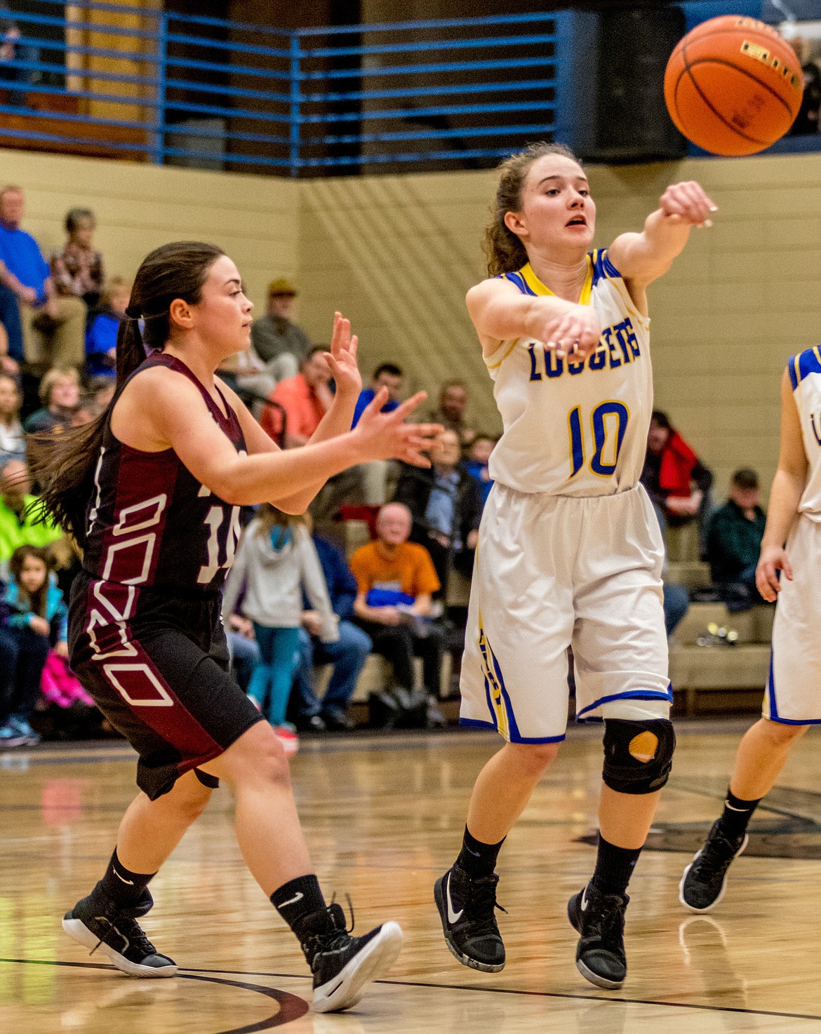 Lady Logger Emma Gruber fires off a pass as Troy&#146;s Emily Ramirez defends Thursday, Jan. 25. (John Blodgett/The Western News)