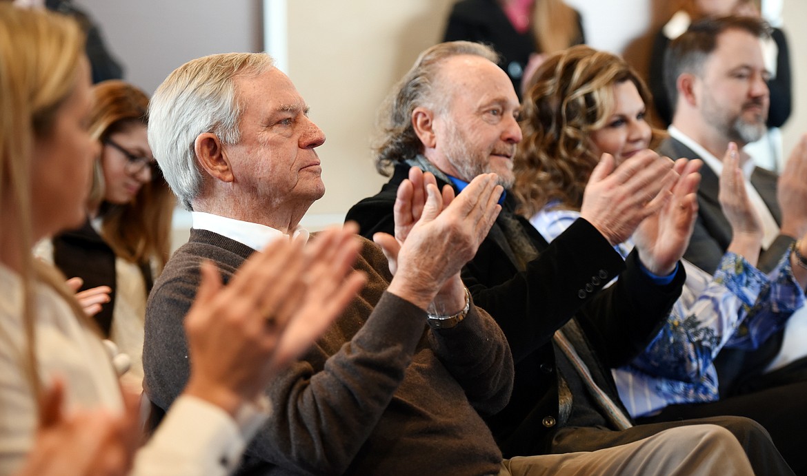 Jerome Broussard and John Zoltek applaud as Flathead Valley Community College President Jane Karas announces the ONE Campaign will partner with the Glacier Symphony and Chorale to provide among other things a permanent home for the symphony.(Brenda Ahearn/Daily Inter Lake)