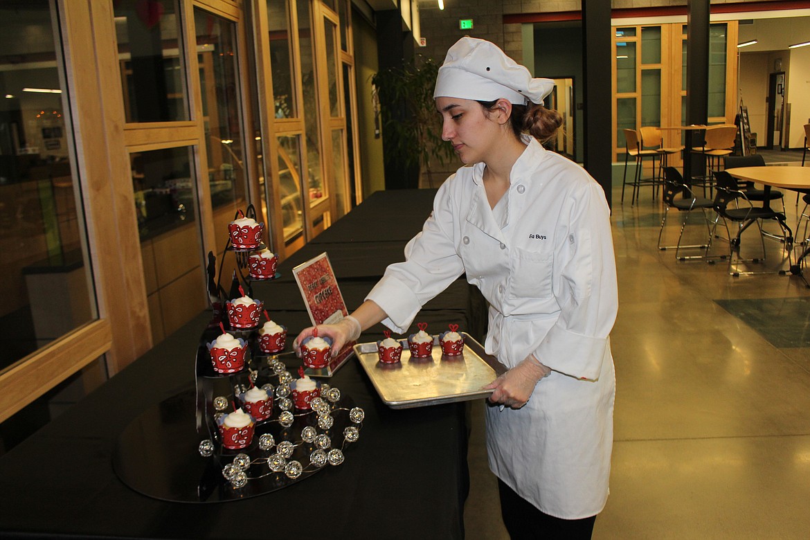 Cheryl Schweizer/Columbia Basin Herald
Eva Buys fills her cupcake display in the preparation for the &#145;Cupcake Wars&#146; competition at CB Tech Tuesday.