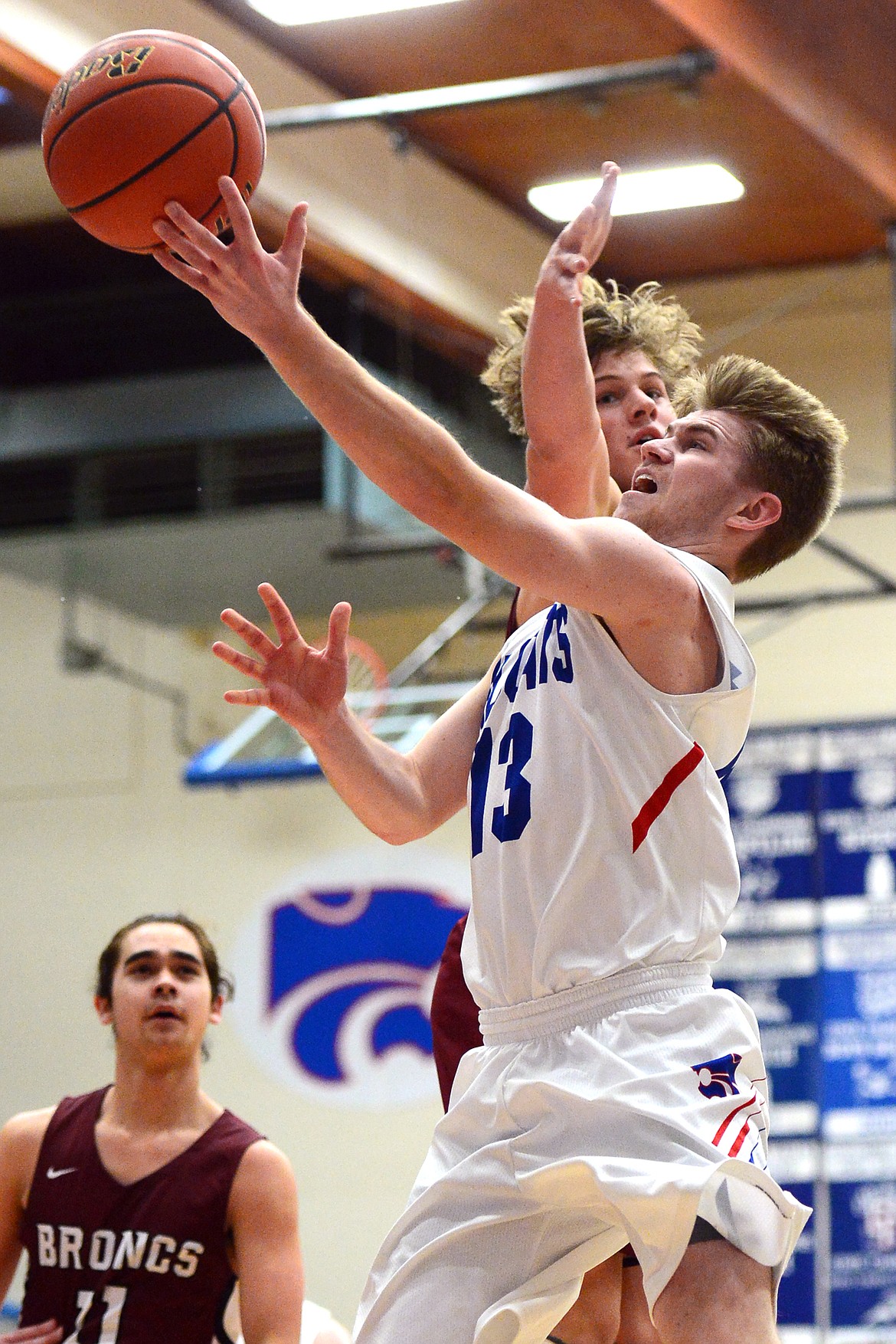 Columbia Falls&#146; Lowell Panasuk drives to the basket with Hamilton&#146;s Carson Rostad defending at Columbia Falls High School on Saturday. (Casey Kreider/Daily Inter Lake)