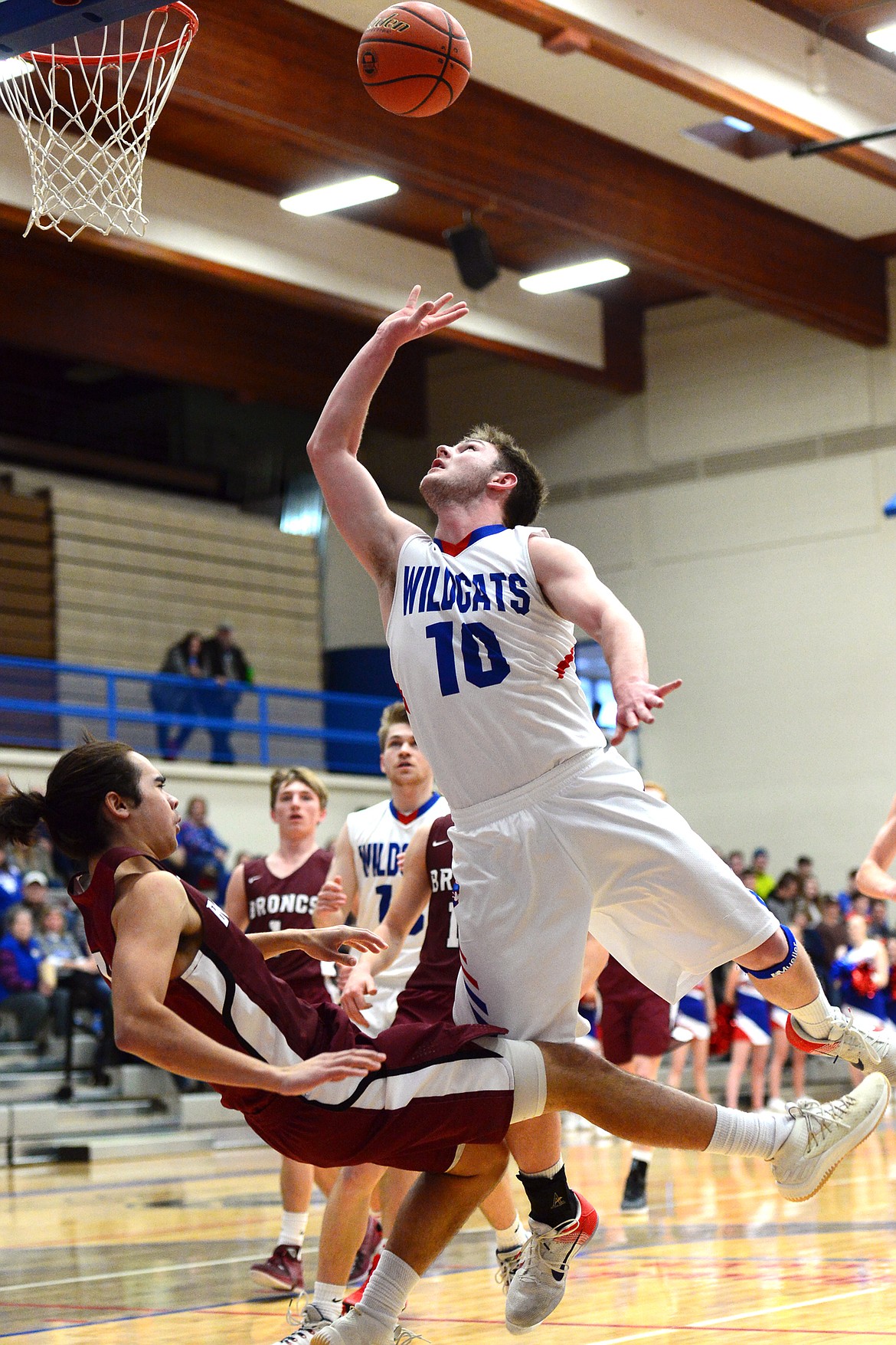 Columbia Falls&#146; Austin Green sinks the bucket and the ensuing free throw after being fouled on his way to the hoop by Hamilton&#146;s Tyler Barnes at Columbia Falls High School on Saturday. (Casey Kreider/Daily Inter Lake)