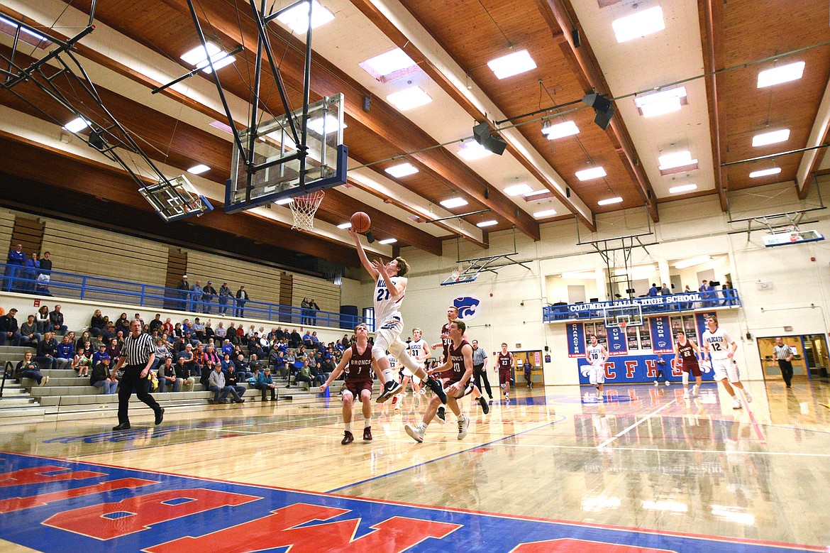 Columbia Falls&#146; Quintin Schriver lays in two points off the opening tip against Hamilton at Columbia Falls High School on Saturday. (Casey Kreider/Daily Inter Lake)