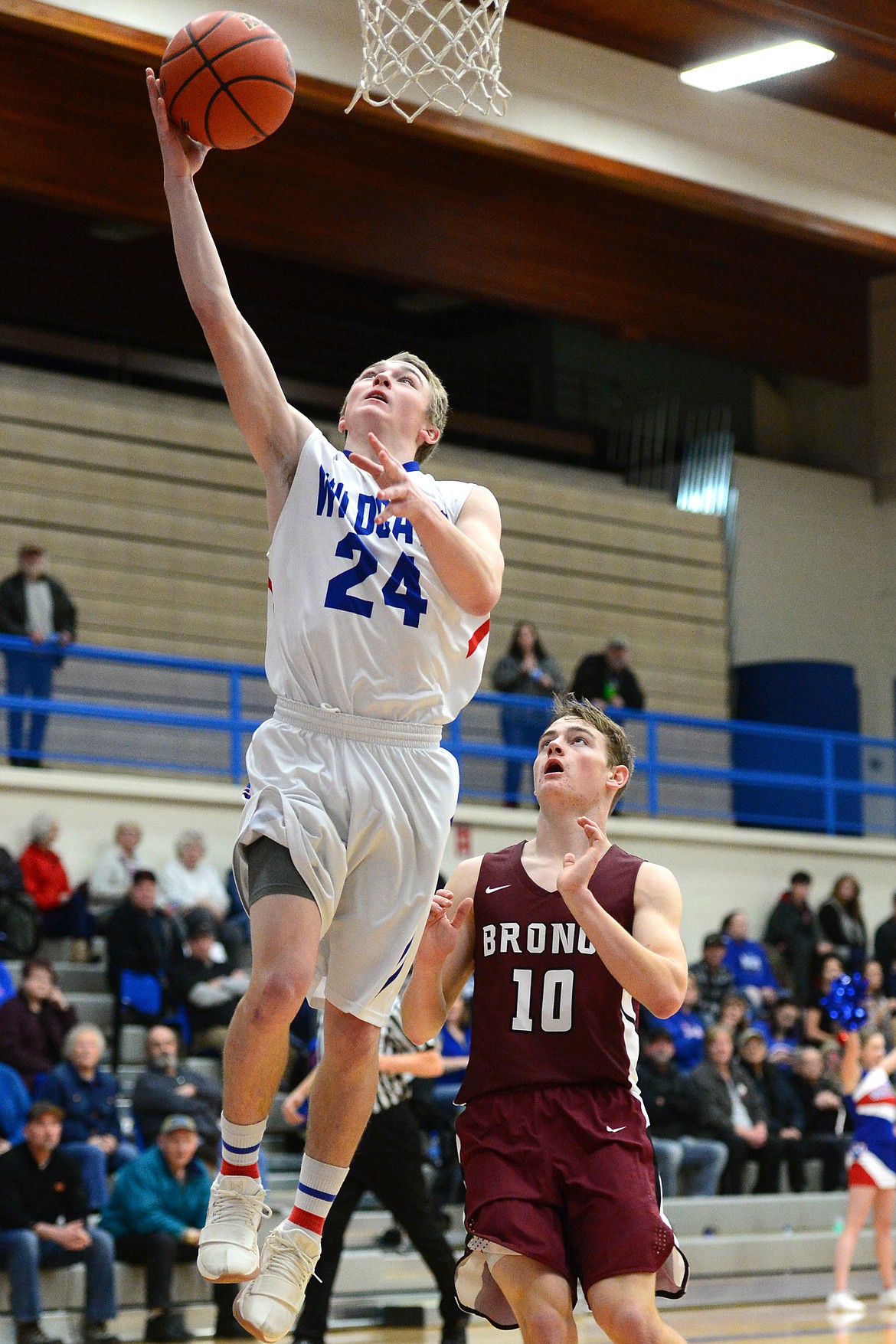 Columbia Falls&#146; Logan Bechtel lays in two points ahead of Hamilton&#146;s Tyler Chouinard at Columbia Falls High School on Saturday. (Casey Kreider/Daily Inter Lake)