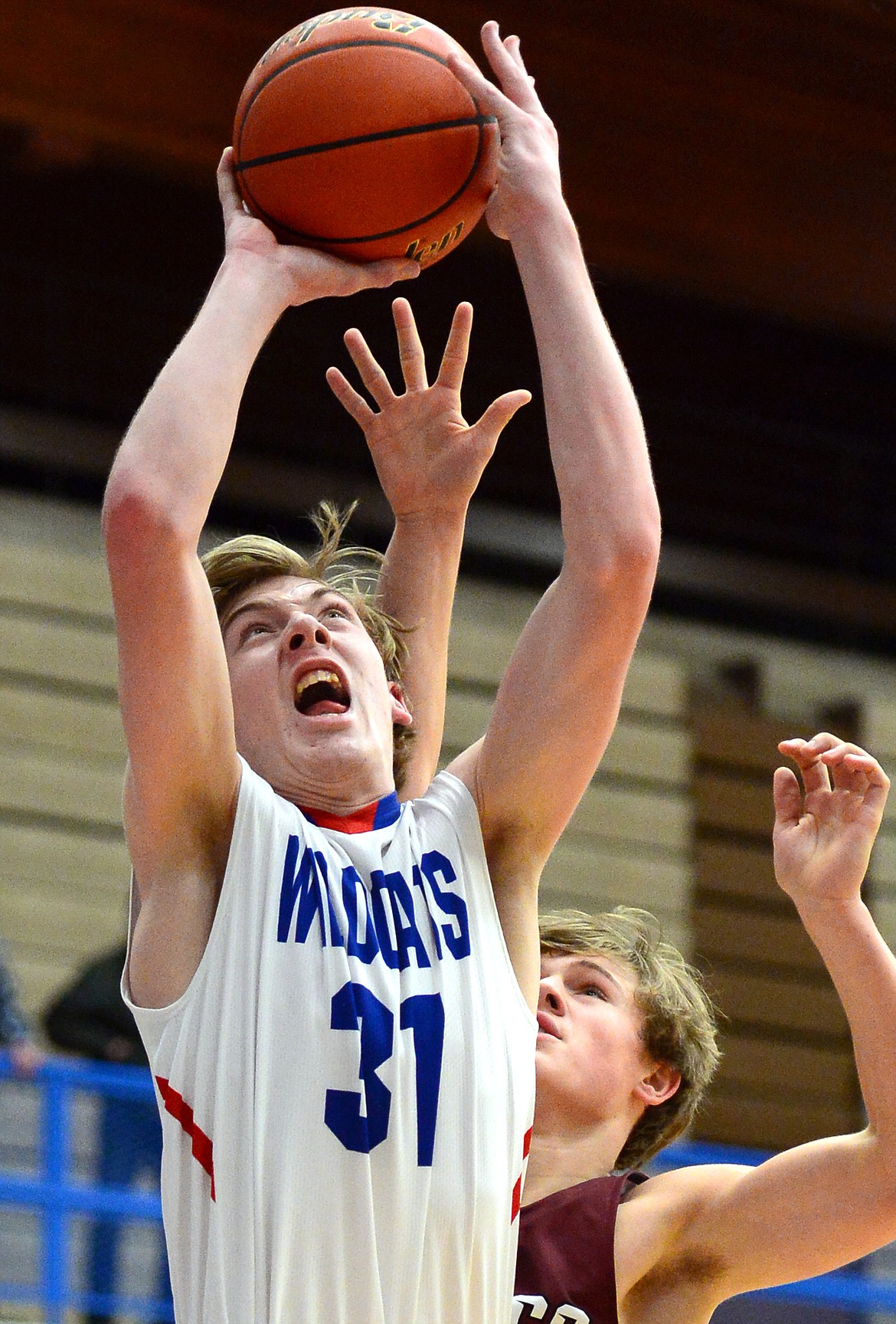 Columbia Falls&#146; Matthew Morrison drives to the basket with Hamilton&#146;s Carson Rostad defending at Columbia Falls High School on Saturday. (Casey Kreider/Daily Inter Lake)