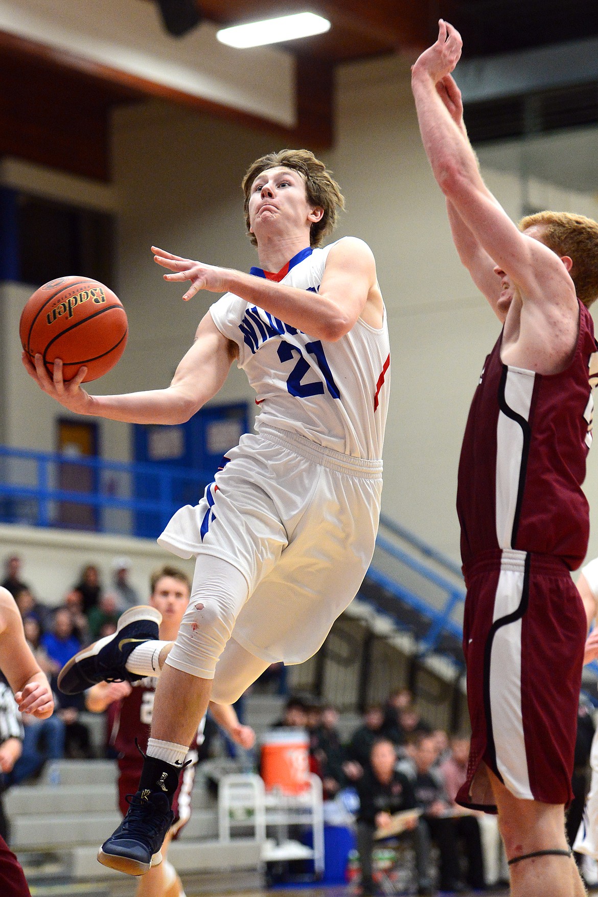 Columbia Falls&#146; Quintin Schriver drives to the hoop with Hamilton&#146;s Carter Kearns defending at Columbia Falls High School on Saturday. (Casey Kreider/Daily Inter Lake)