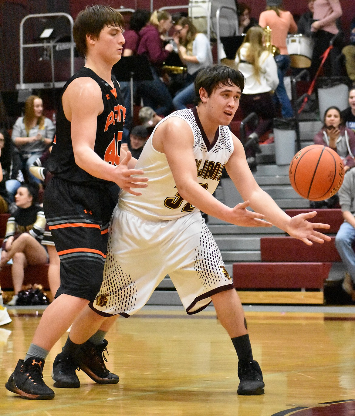 Troy&#146;s Tyler Gromley takes a pass against Plains defender Jay Voncheeder Friday night in Troy. (Photo by Svetlana Harper)