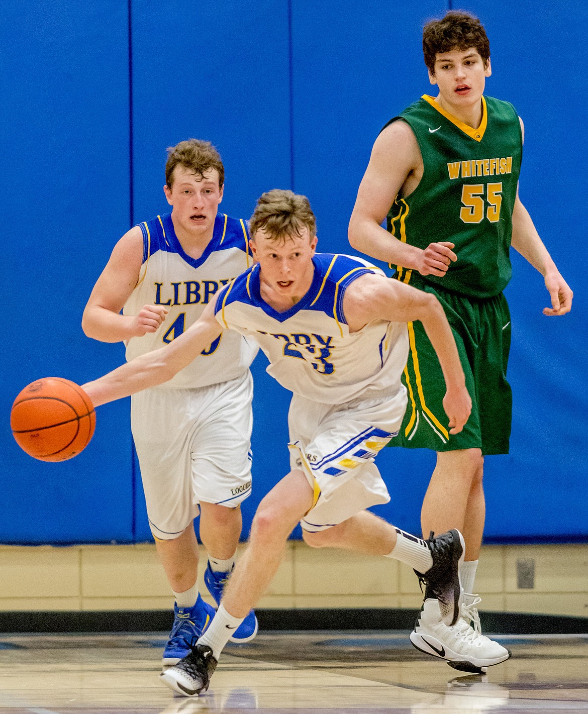 Libby&#146;s Ryggs Johnston takes the ball before teammate Nik Jones and Whitefish&#146;s Dillon Botner Friday in Libby.