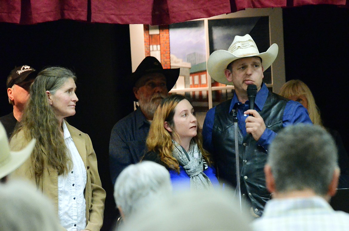 AndreParker, wife of Eric Parker, stands with Roxsanna Ryan and Ryan Bundy to standing ovation.  (Erin Jusseaume/ Clark Fork Valley Press)