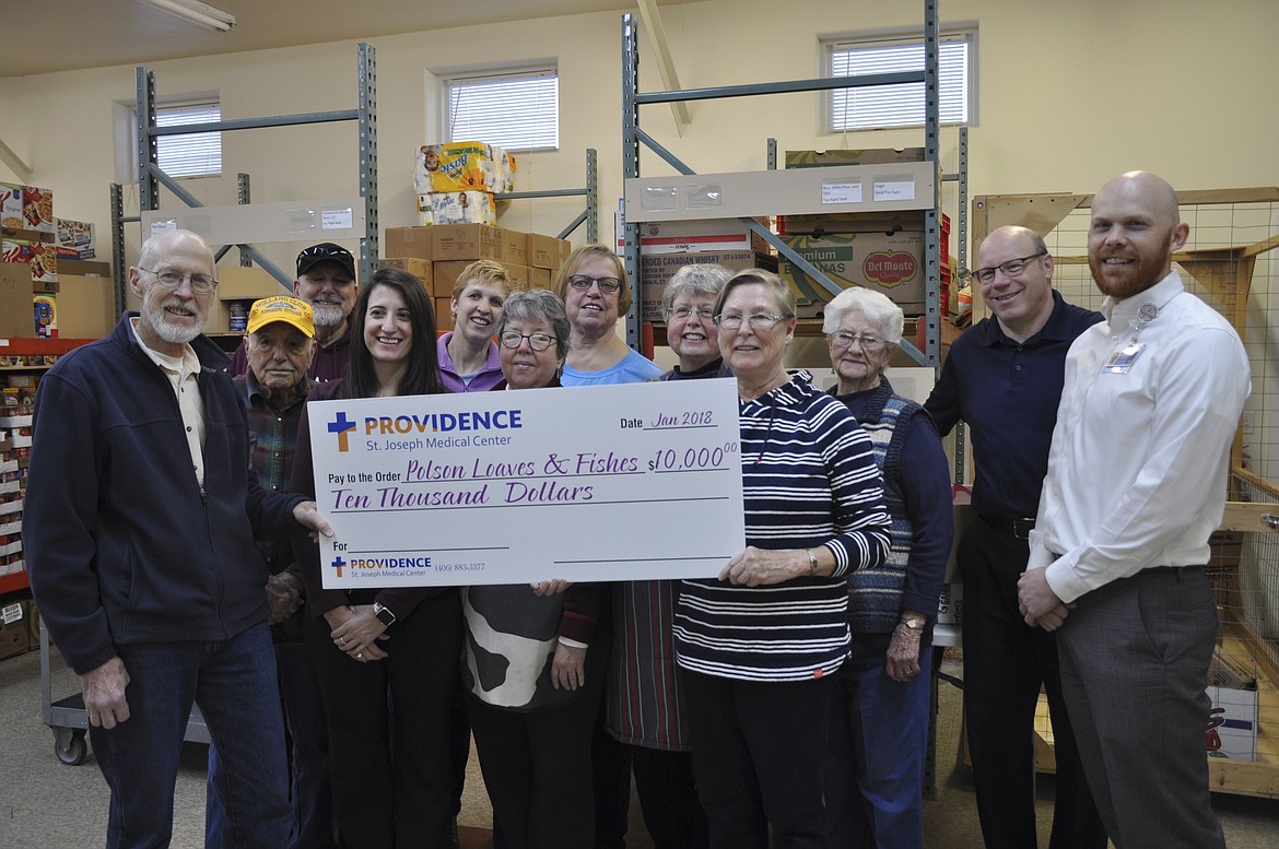 BOARD MEMBERS and volunteers from Polson Loaves and Fish accepted a donation of $10,000 from Providence St. Joseph Medical Center last week, which will help purchase needed items. (Ashley Fox/Lake County Leader)