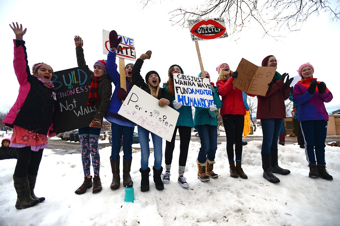 From left, Apani Awua, 10, Abbey, Biel, 11, Elyse Byrd, 12, Eddie Chisholm, 12, Sheridan Skerritt, 13, Eloise McKeon, 13, Siri Erickson, 13, Ava Foley, 13 and Julia Martin, 13, all of Columbia Falls, cheer during one of many speakers at the Women's March in Depot Park in downtown Kalispell on Saturday, Jan. 20. (Casey Kreider/Daily Inter Lake)