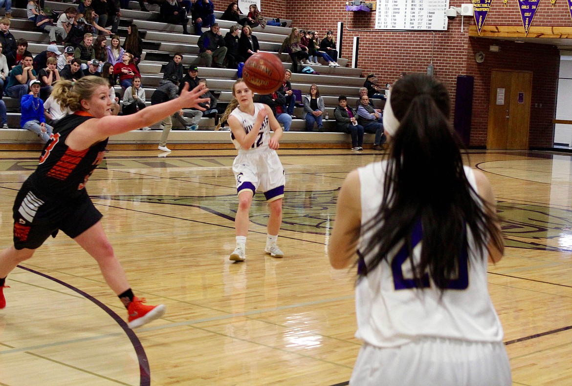 Photo by Chanse Watson 
Erin Van Hoose sneaks a pass to Jaron Figueroa as a Priest River defender attempts to get the steal.