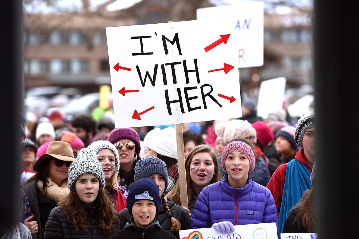 Attendees hold signs and listen to a host of speakers during the Women's March in Depot Park in downtown Kalispell on Saturday, Jan. 20. (Casey Kreider/Daily Inter Lake)