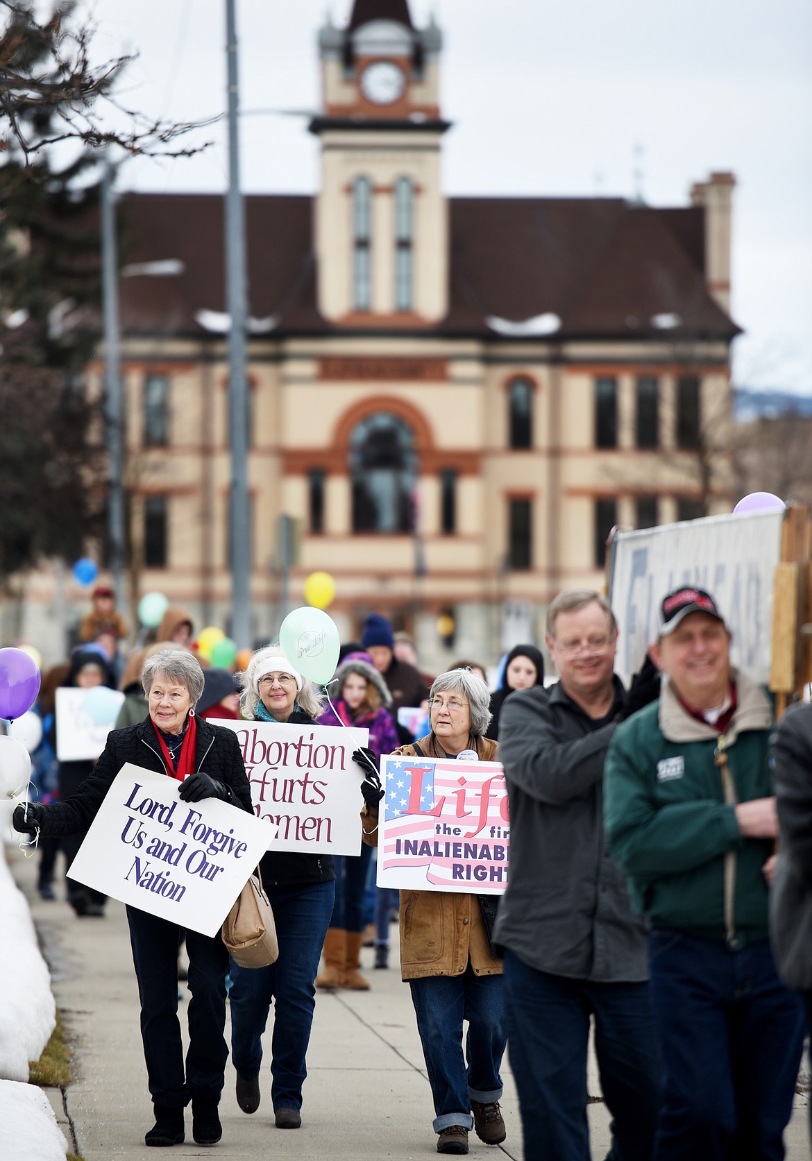 From left, Mae Osborne, Karen Holmquist, and Connie Coyle and others take part in the annual Pro-Life March down Main Street on Saturday afternoon, January 20, in Kalispell. The event began with a keynote address from Dr. Al Olszewski, who also served as keynote speaker at an event in Helena on Friday, and one in Billings today.(Brenda Ahearn/Daily Inter Lake)