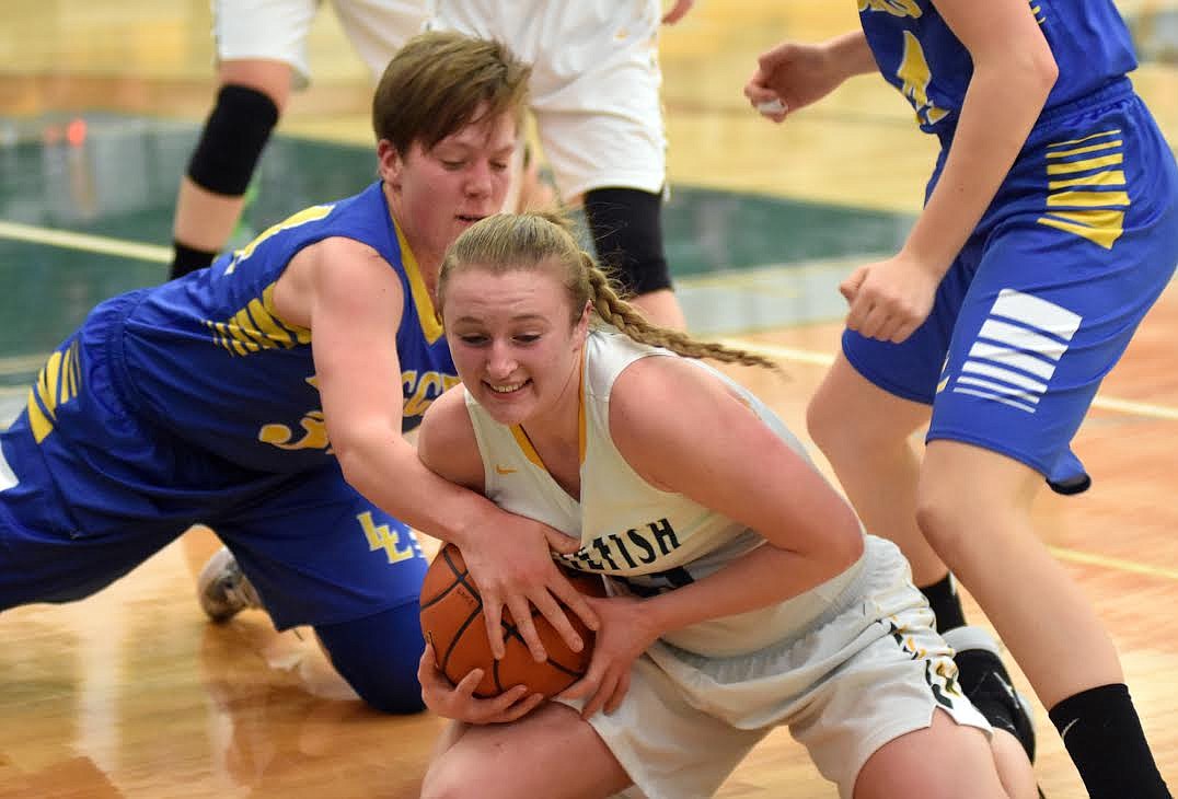 Lady Bulldog Annisa Brown fights for a jump against the Lady Loggers Friday night in Whitefish. The Loggers outscored the Bulldogs 47-29. (Heidi Desch/Whitefish Pilot