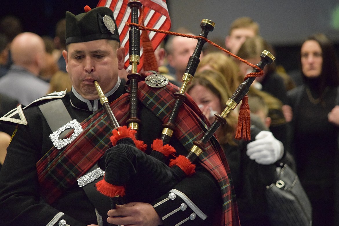 Charles H. Featherstone/Columbia Basin Herald
A piper leads the family of fallen Grant County firefighter Dan Dishon out following the conclusion of a memorial service for Dishon on Saturday.