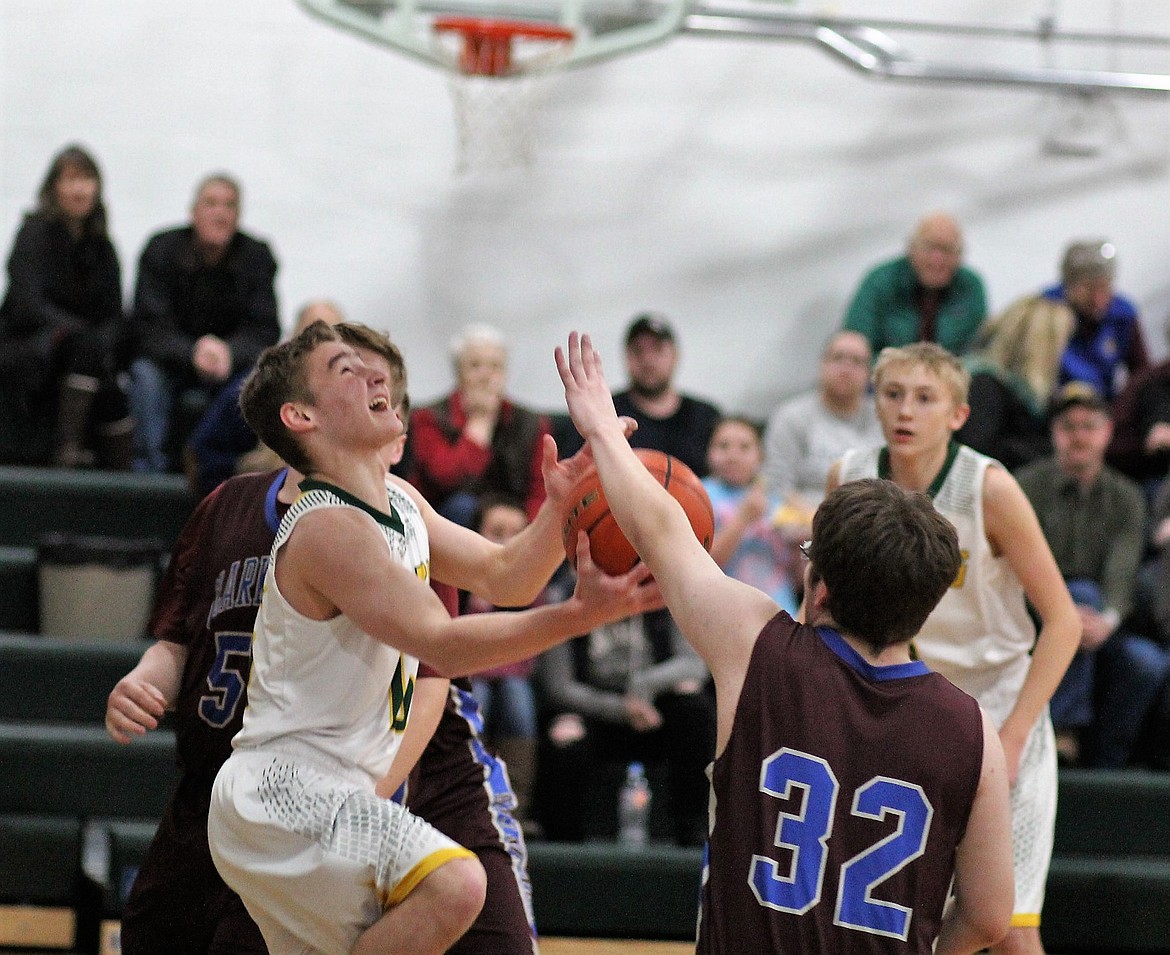 St. Regis player, Ian Farris, goes in for a basket during their game against cross-county rivals, the Clark Fork Mountain Cats on Thursday in St. Regis. (Kathleen Woodford/Mineral Independent).