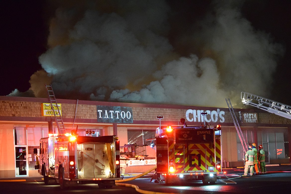 Charles H. Featherstone/The Columbia Basin Herald
Moses Lake firefighters deal with a fire at Chico&#146;s Pizza Parlor Saturday evening.